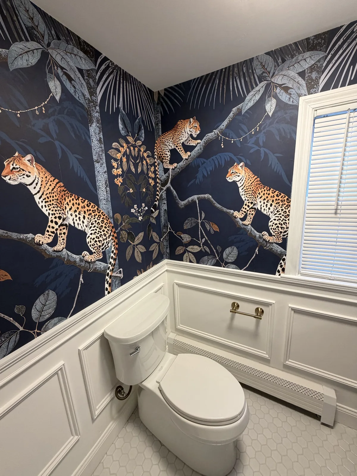 Custom basement powder room with feature wallpaper