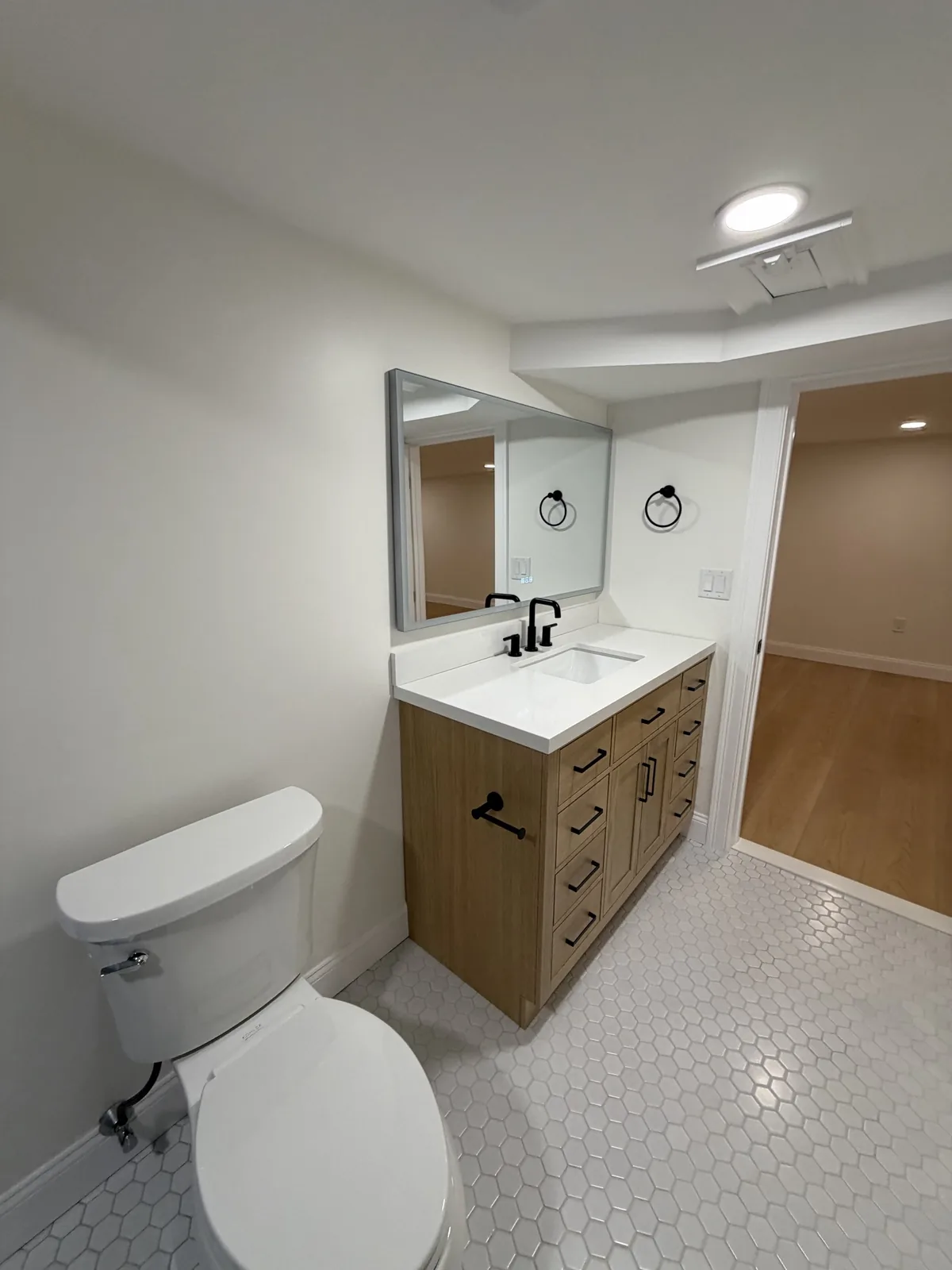 Basement bathroom with wood vanity